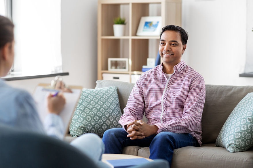 Relieved man undergoing individual therapy for addiction.