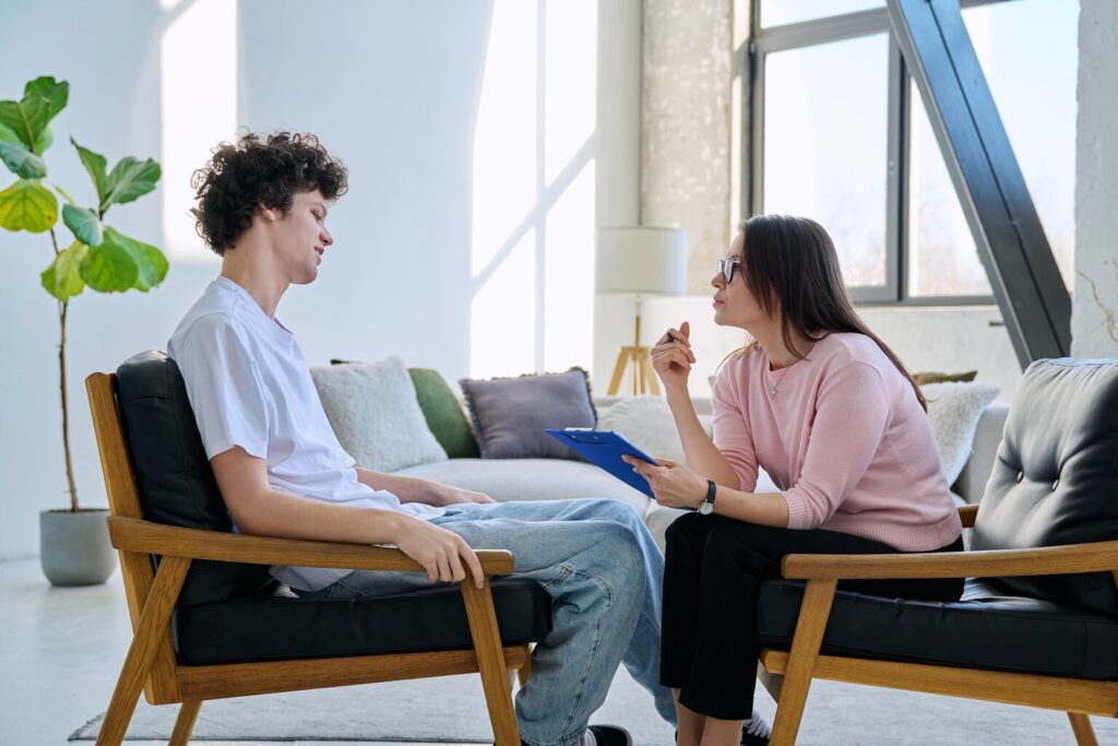 Young man and young therapist have conversation about the dangers of cocaine.