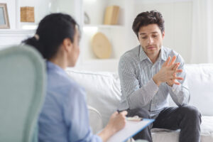 Man describing bath salts to a therapist with clipboard.