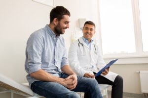 Doctor explaining opioid detox to friendly man.