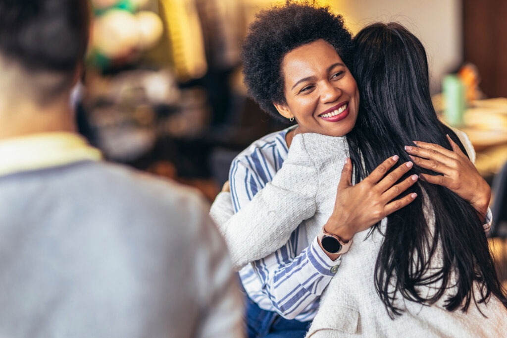 Woman embracing younger woman saying goodbye before going to rehab.